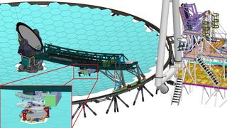 The Segment Handling System (SHS) and its precision robotic hand, which traverses under the bridge